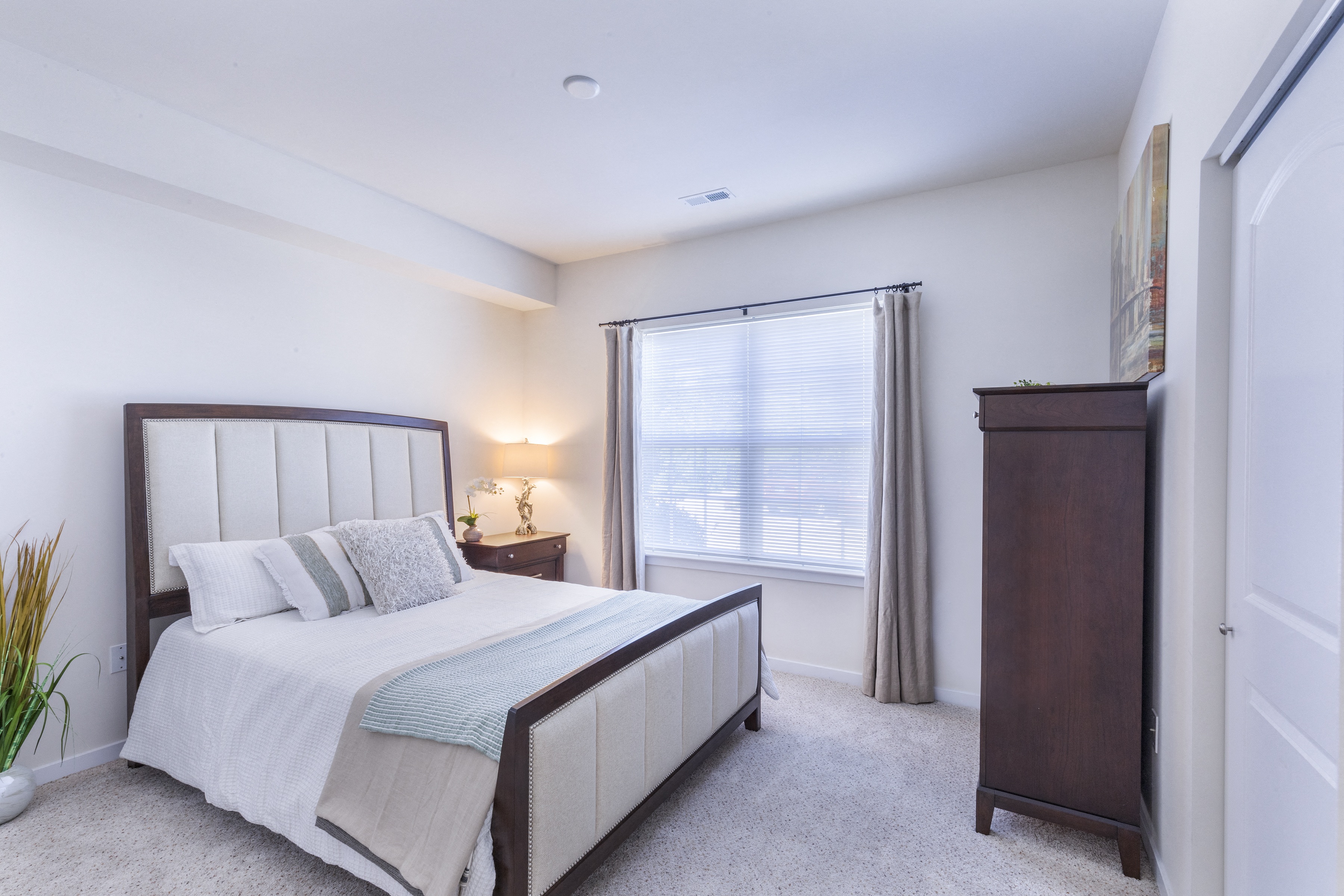 a bedroom with a bed and a dresser and a window at Aventura at Towne Centre, Ellisville, 63011